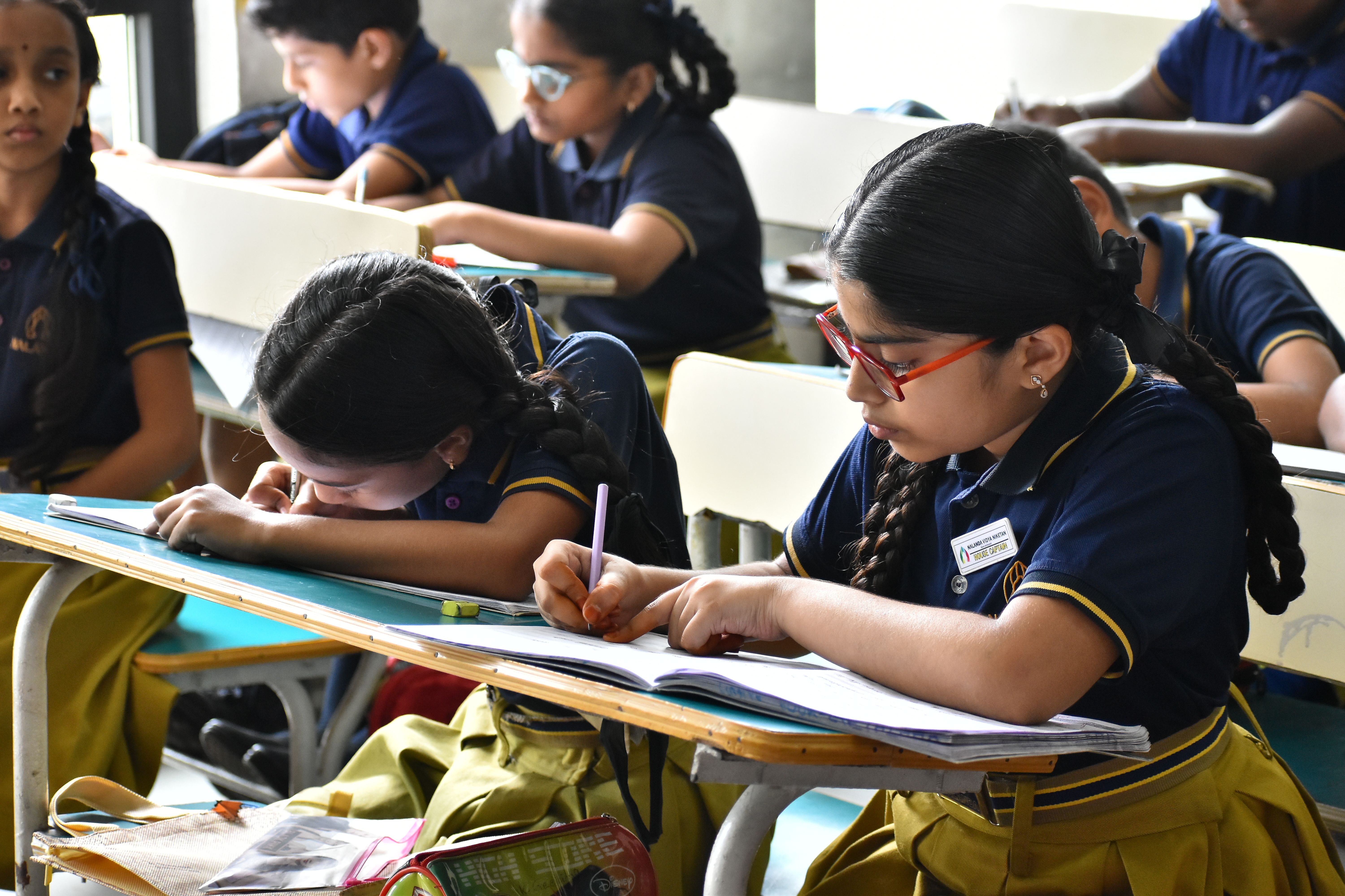 student writing on notebook