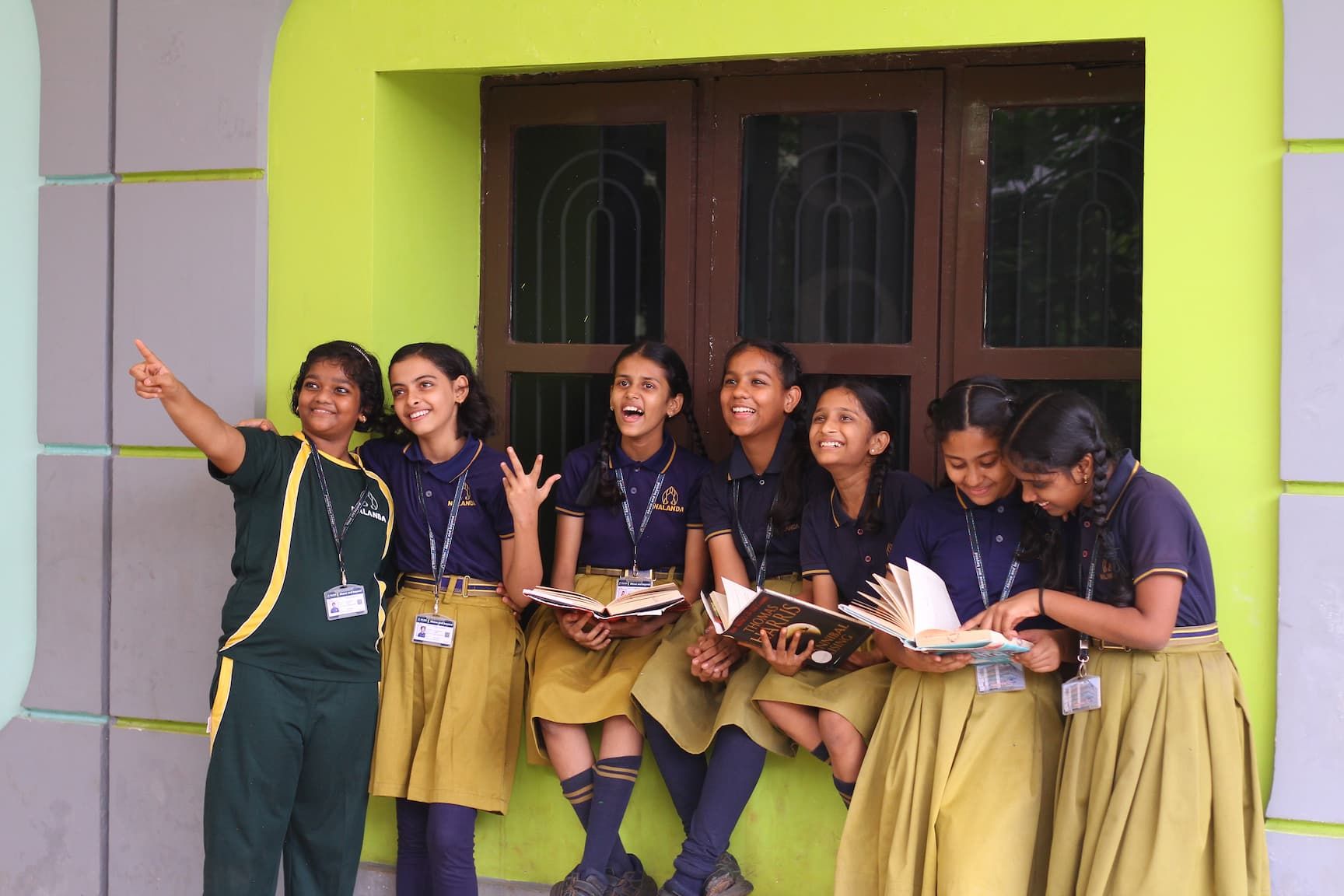 a child working on robots and teacher teaching to her