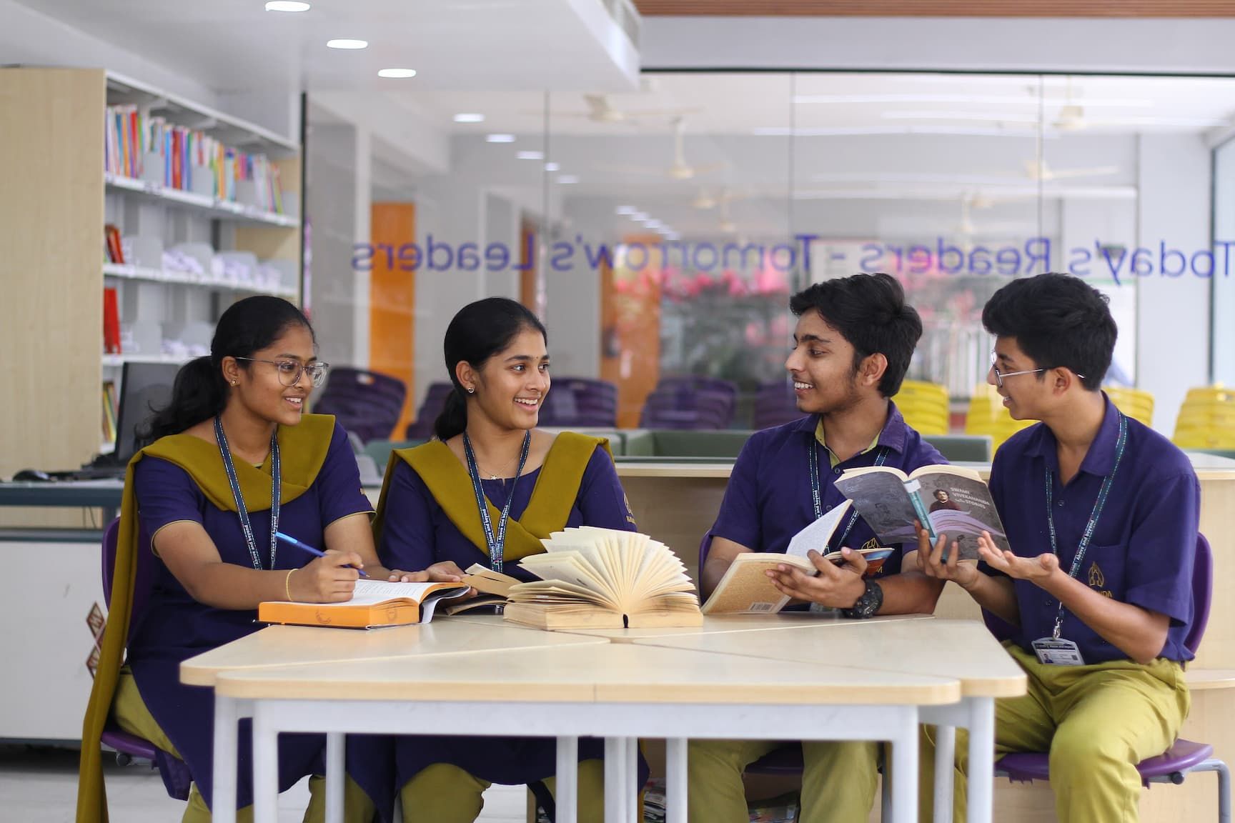 a child working on robots and teacher teaching to her
