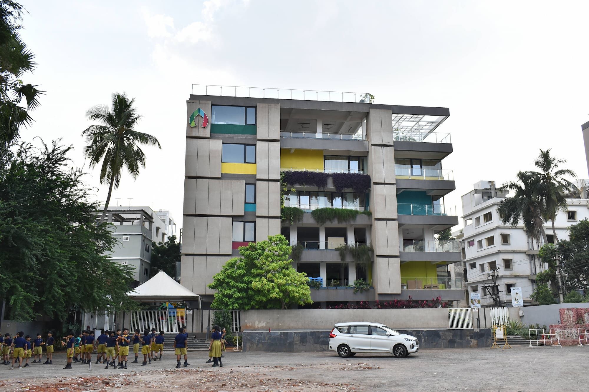a child working on robots and teacher teaching to her