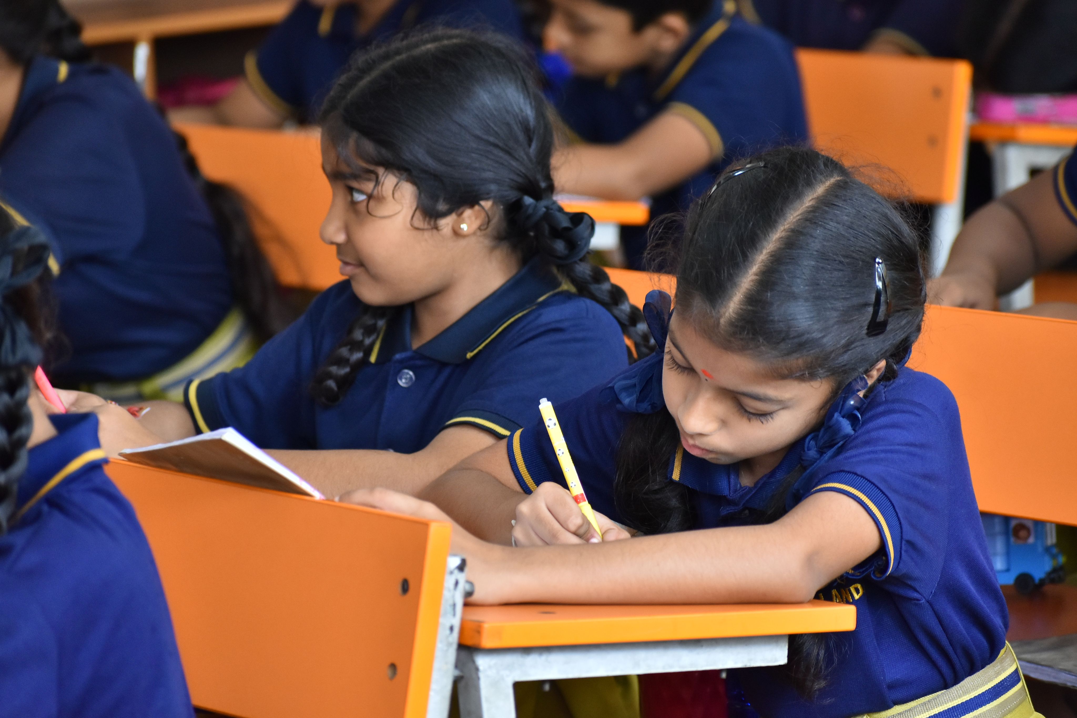 student writing on notebook